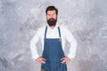 Professional baker in apron. serious barista with beard. advertisement and food. cook wear professional apron. express