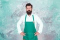 Professional baker in apron. serious barista with beard. advertisement and food. cook wear professional apron. express