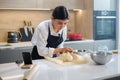 Professional Baker Girl Makes Final Touches in Cooking Bread.