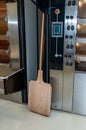 Professional baker`s oven and wooden shovel