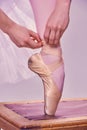 Professional ballerina putting on her ballet shoes.