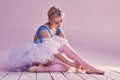 Professional ballerina putting on her ballet shoes. Royalty Free Stock Photo