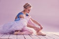 Professional ballerina putting on her ballet shoes Royalty Free Stock Photo