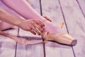 Professional ballerina putting on her ballet shoes Royalty Free Stock Photo