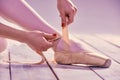 Professional ballerina putting on her ballet shoes Royalty Free Stock Photo