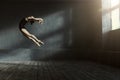 Professional ballet dancer performing in the dark lighted room