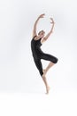 Professional Ballet Dancer Young Athletic Man in Black Suit Posing in Ballanced Dance Pose Studio On White