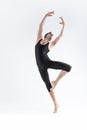 Professional Ballet Dancer Young Athletic Man in Black Suit Posing in Ballanced Dance Pose Studio On White