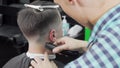 Professional barber giving a haircut to a male customer Royalty Free Stock Photo