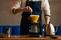 Professional Barista or coffee barman prepares coffee