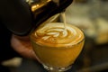 Barista making coffee latte art in crystal glass.sensitive focus