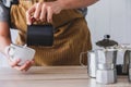 The professional of a barista poured milk. making hot coffee with equipment, tool brewing on bar at kitchen home