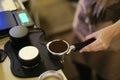 Barista prepare grinded coffee into portafilter for espresso brewing process