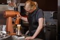 Professional barista preparing coffee using chemex