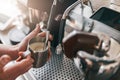 Professional barista warming milk In metal jug with steam of coffee machine Royalty Free Stock Photo