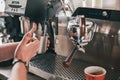 Professional barista warming milk In metal jug with steam of coffee machine Royalty Free Stock Photo