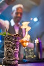 Professional barman making a tropical cocktail with fire flames at party in a nightclub. Nightlife concept. Royalty Free Stock Photo