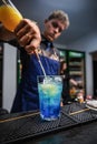 Professional bartender making cocktail