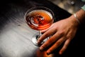 Professional bartender with red cocktail into a martini glass Royalty Free Stock Photo