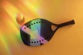 Professional beach tennis racket and ball on holographic colors background Royalty Free Stock Photo