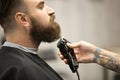 Professional beard grooming at barbershop Royalty Free Stock Photo