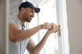 Professional handyman fixing window handle at home. Royalty Free Stock Photo