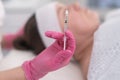 Professional beautician holding syringe to smoothing wrinkles with injections. mesotherapy