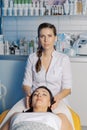 Professional beautician woman prepares client for cosmetology procedure. Royalty Free Stock Photo