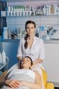 Professional beautician woman prepares client for cosmetology procedure. Royalty Free Stock Photo