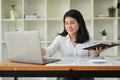 Beautiful Asian businesswoman working at her office desk, using laptop computer Royalty Free Stock Photo