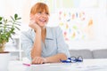 Professional beautiful young woman sitting her desk at her home Royalty Free Stock Photo