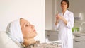 Professional beauty clinic worker in coat prepares tools