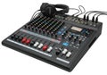 Professional black audio mixing console with multiple knobs and headphones on top Royalty Free Stock Photo