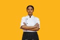 Professional black female chef in white uniform standing with her arms crossed Royalty Free Stock Photo