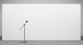 Microphone on Stand in Front of Blank White Screen with Copy Space Royalty Free Stock Photo