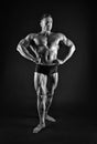 Professional bodybuilder. Bodybuilder black background. Fit bodybuilder show muscular body. Strong bodybuilder with six