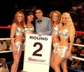 Professional Boxing referee with round card girls.