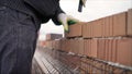 Professional bricklaying during the construction of a house. The construction of walls made of expensive red bricks