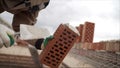 Professional bricklaying during the construction of a house. The construction of walls made of expensive red bricks