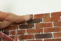 Professional builder gluing decorative brick on wall, closeup. Tiles installation process Royalty Free Stock Photo