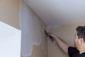 Professional builder smooths wall with spatula putty put on leveled surface of wall Royalty Free Stock Photo