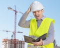 Professional builder standing with a notebook