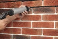 Professional builder using tiling fugue for grouting, closeup Royalty Free Stock Photo