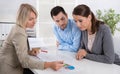 Professional business meeting: young couple as customers and an Royalty Free Stock Photo