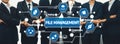 Professional Business Team Collaborating on File Management Concepts with Technology Icons Illustrating Data Processes Royalty Free Stock Photo