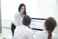 Professional business team discussing marketing graphics at the desktop. Royalty Free Stock Photo