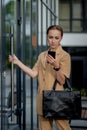 Professional business woman using mobile phone outdoors. Female texting on smart phone while walking outdoor in city Royalty Free Stock Photo