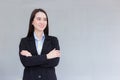 Professional business working Asian woman who wear a black formal suit stands with crossing her arm smiles happily at office as Royalty Free Stock Photo