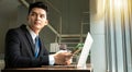 Professional Businessman By Window Working On Laptop In Coffee Shop Royalty Free Stock Photo