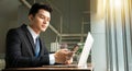 Professional Businessman By Window Working On Laptop In Coffee Shop analyzing information Royalty Free Stock Photo